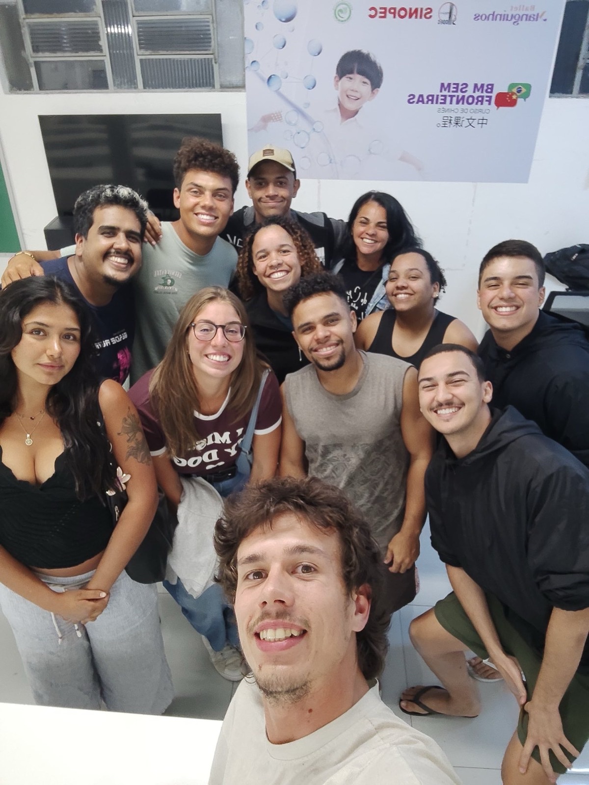 A large group of volunteers and team members taking a selfie together.